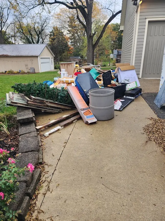 Dumpster being loaded with debris for Residential Dumpster Rental in Waterloo